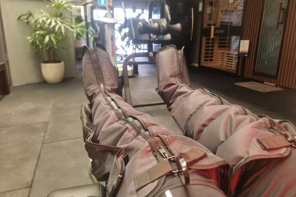 Intermittent pneumatic compression boots set up for leg recovery, circulation improvement, and reduced muscle soreness.