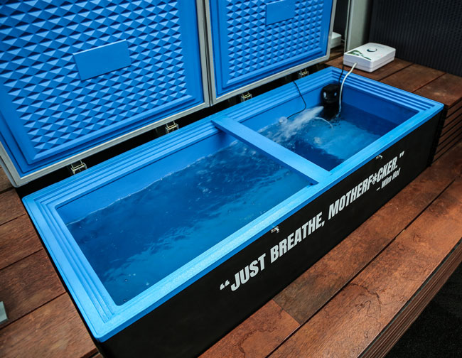 Cold plunge setup with circulating ice water for physical recovery and mental resilience training.